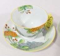TWO BUTTERFLY HANDLE CUPS AND SAUCERS