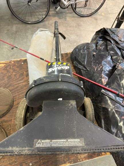 Tower fan, roll of plastic, fishing pole, shop sweeper