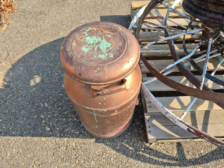 6 Old Spoked Wheels of Various Sizes and 1 Old Style Metal Milk Container