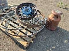 6 Old Spoked Wheels of Various Sizes and 1 Old Style Metal Milk Container