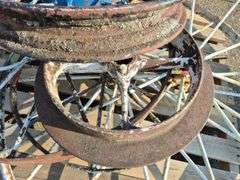 6 Old Spoked Wheels of Various Sizes and 1 Old Style Metal Milk Container