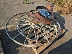 6 Old Spoked Wheels of Various Sizes and 1 Old Style Metal Milk Container