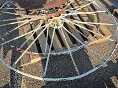 6 Old Spoked Wheels of Various Sizes and 1 Old Style Metal Milk Container