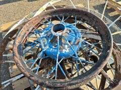 6 Old Spoked Wheels of Various Sizes and 1 Old Style Metal Milk Container