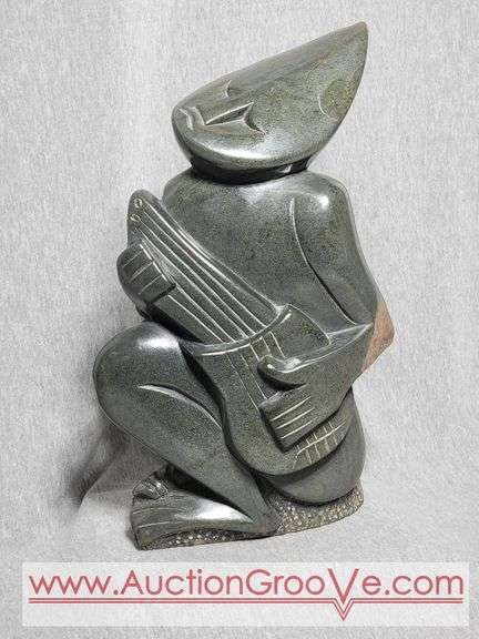Shona Musician Playing a Guitar. Has a chip on his knee. 13 x 8 x 3.5. B2