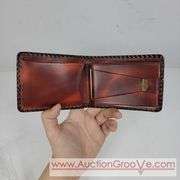 Two Vintage Hand Tooled Leather Wallets. A