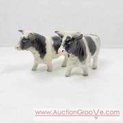 Victoria Ceramics Cow Salt and Pepper Shakers and Kirk Pewter. Both cow sets have one damaged horn each. See photos. A