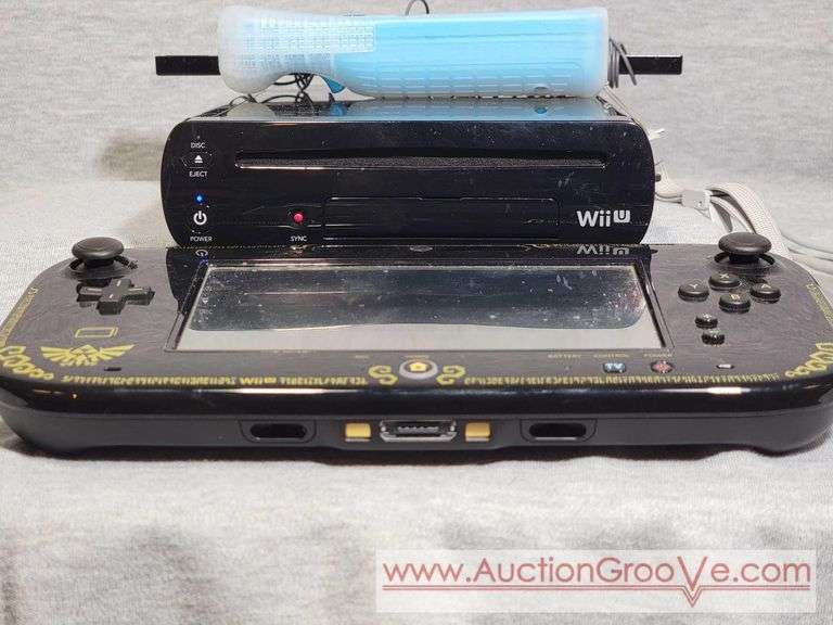 Wii U with Gamepad. The Gamepad appears to be missing a charger. The wii console powers on and appears to be in working order. One control, and antenna. I am not 100% sure this is a complete set, plea