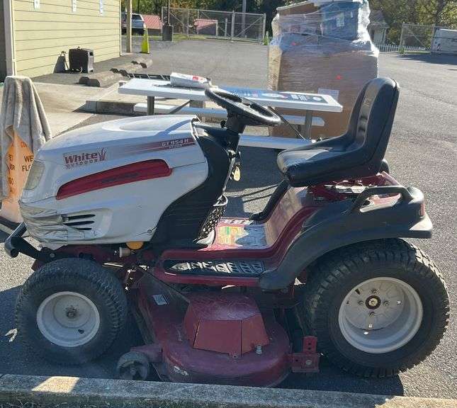 White outdoor riding lawnmower, 54”cutting deck, GT 954H, the item works as should forward and reverse, blades engage, powered by Kohler, the item does have cosmetic damage but shouldn't affect the actual function of the machine