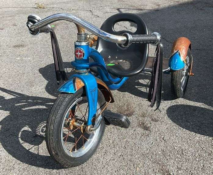 Schwinn tricycle, blue/chrome fenders, wide rubber grip handles with faux leather tassels, fenders are rusty and tires need air