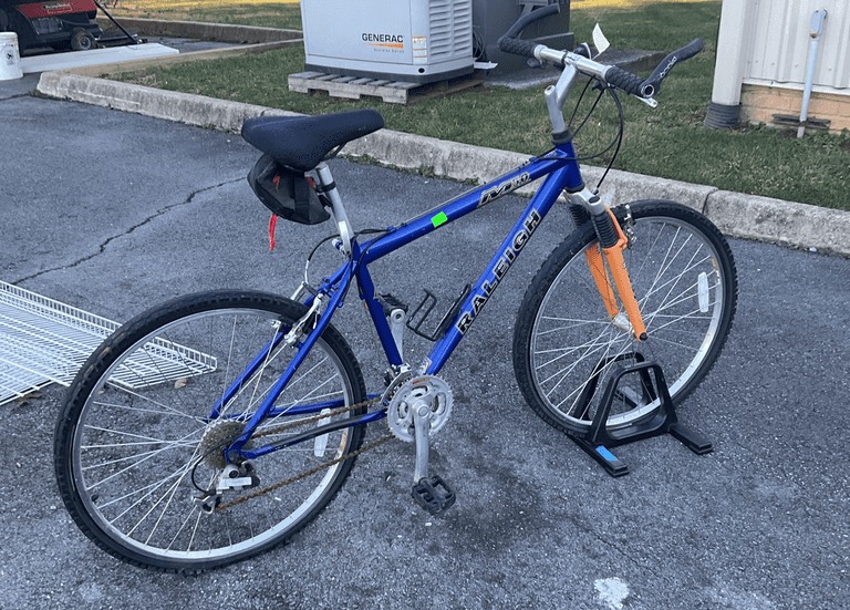 Raleigh bike, 21 speed, rubber grip handlebars, tires need replaced and chain is rusty