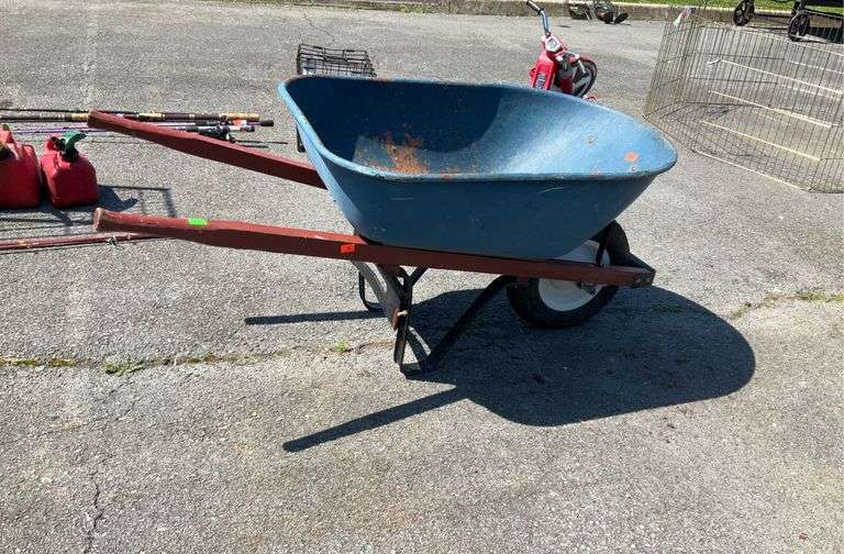 Wheelbarrow, metal body, two wooden handles, tire need air and some rust