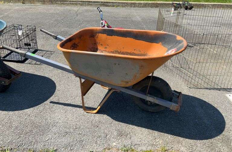 True temper wheel barrow, two poly grip handles, metal hopper, some rust and tire is damaged