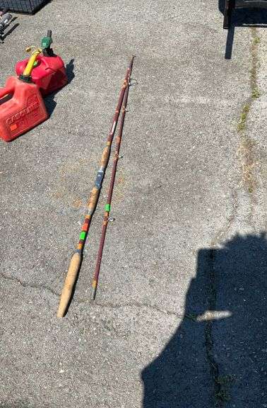Fishing pole, wooden handle, some of the cork is peeling