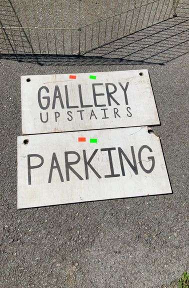 Two wooden signs, gallery and parking, 12”H x24”L, one corner is damaged