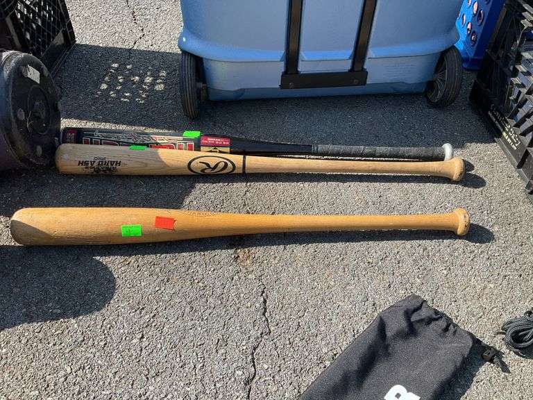 Three baseball bats, two wooden, one metal
