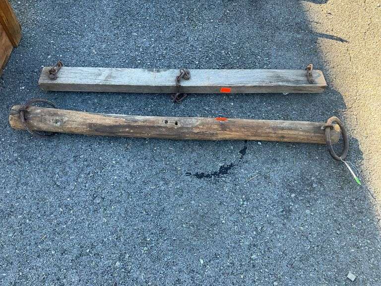 Two Decorative Wooden Yokes with Metal Ring and Chain Details