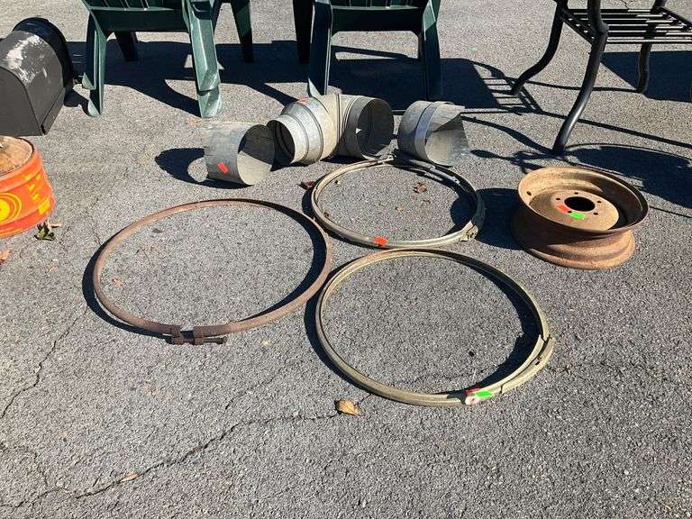 Lot with Tension Rings, Galvanized Pipe Sections, and Five-Lug Wheel