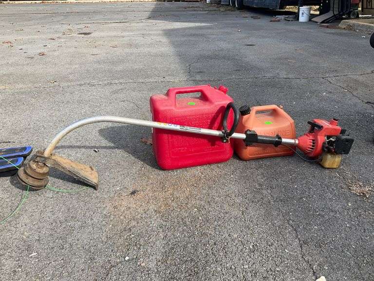 Homelite Weedeater and Two Fuel Cans Including 1- and 5-Gallon Capacities