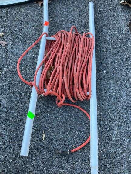Red Extension Cord with Cut Cable and Metal Reel Frame