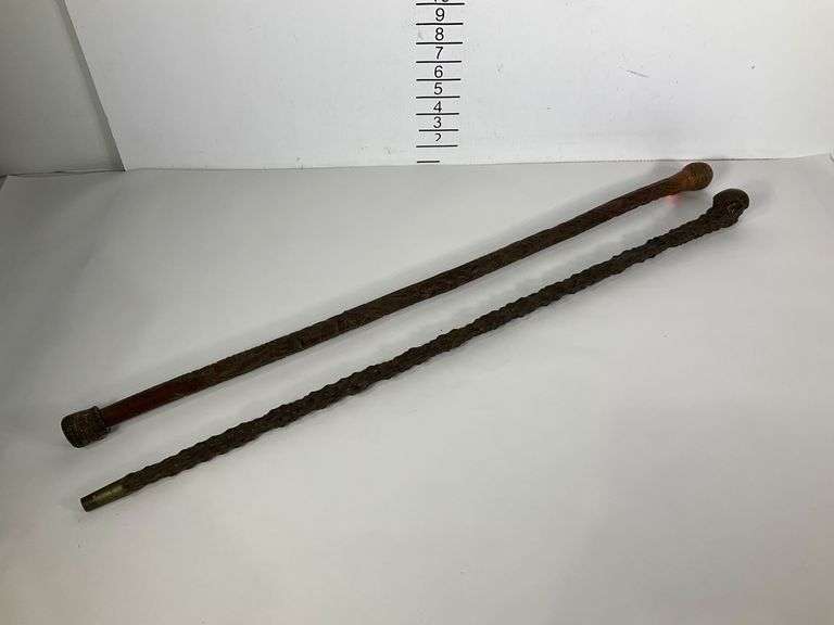 Two 35-Inch Carved Walking Sticks with Decorative Handles - Hash Auctions