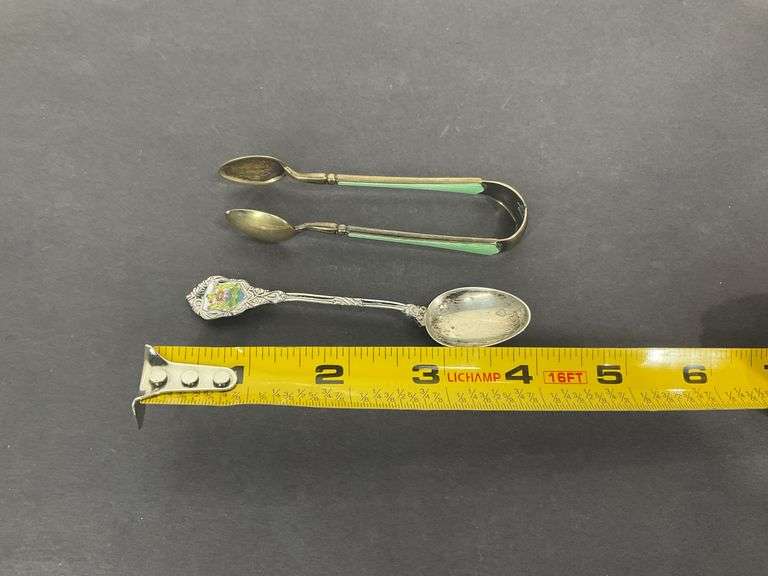 Sterling silver sugar tongs made in Norway and a sterling silver souvenir spoon Hong Kong 25.8grams