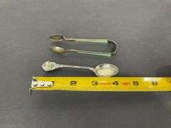 Sterling silver sugar tongs made in Norway and a sterling silver souvenir spoon Hong Kong 25.8grams
