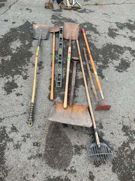 8-Piece Assortment of Yard and Hand Tools Including Shovels, Rakes, and Level