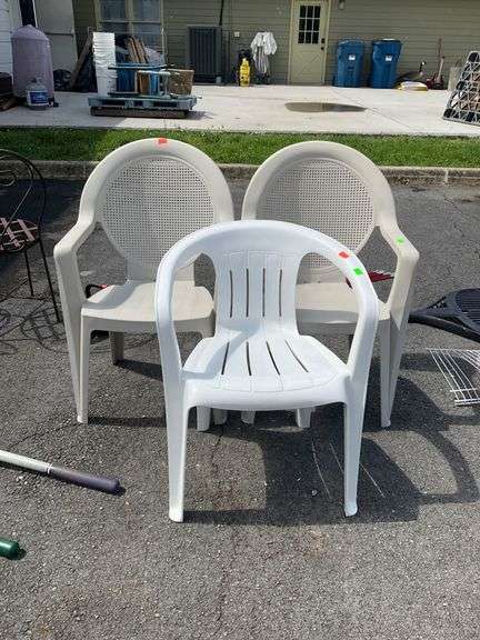 Three Plastic Outdoor Chairs with Perforated and Slatted Designs