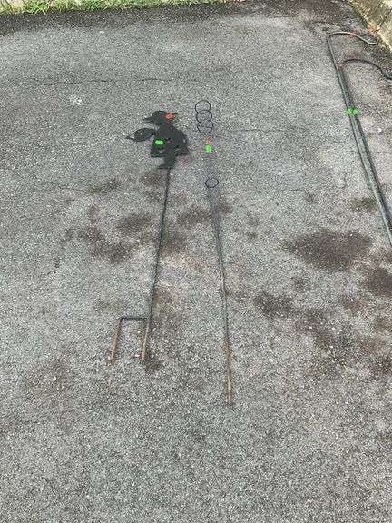 Two Garden Laen Metal decor stakes, one with flower girl figure, one for tiki torch burner I believe about 4 foot tall.