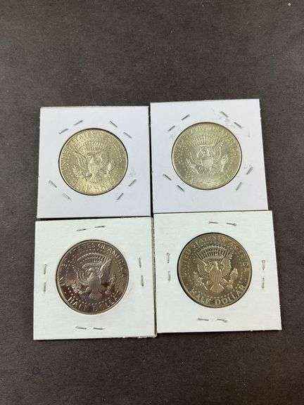 Four Kennedy half dollars 1964(2), 2005, and 1980