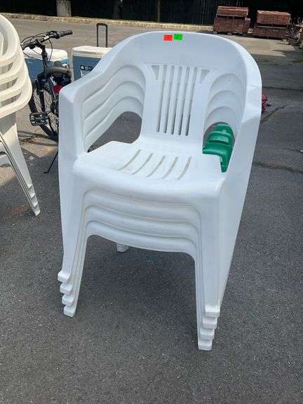 Four White Plastic Stackable Patio Chairs