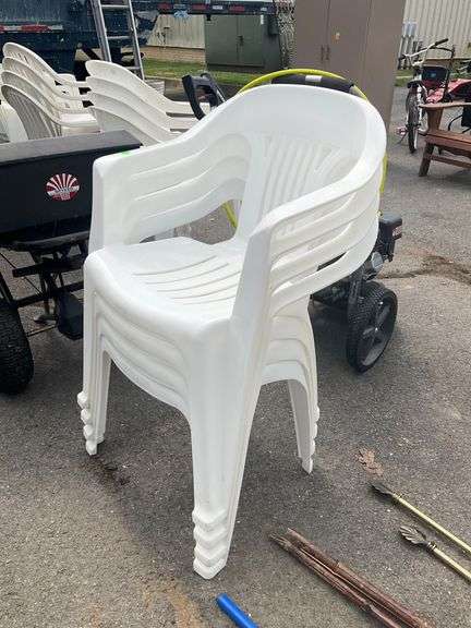Four White Stackable Plastic Patio Chairs