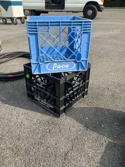 Two Plastic Crates: One Blue Pace and One Black Dairy Maid Dairy