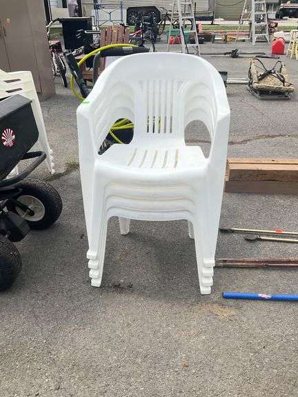 Four White Stackable Plastic Patio Chairs