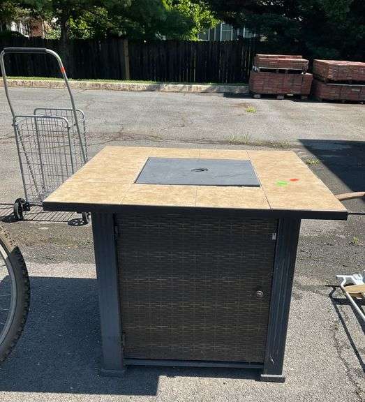 Propane Firepit with Lava Rocks and Woven Cabinet Design
