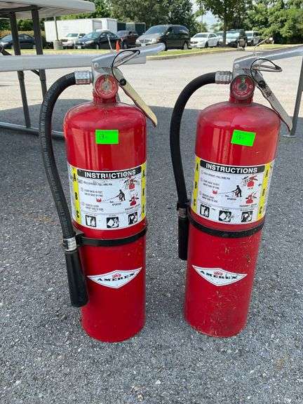 Two Red Fire Extinguishers with Instruction Labels