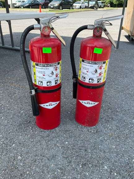 Two Red Fire Extinguishers with Instruction Labels