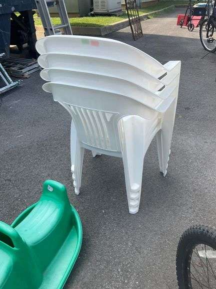 Four White Plastic Stackable Patio Chairs