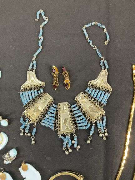 Egyptian style jewelry with bib necklace, necklace with matching earrings, goldtone necklace, clip on earrings, and a Wittnauer wrist watch not running