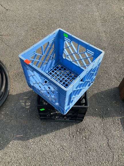 Two Plastic Crates: One Blue Pace and One Black Dairy Maid Dairy