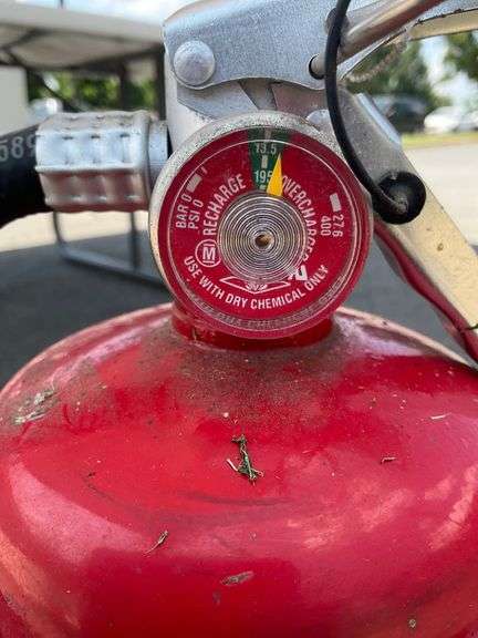 Two Red Fire Extinguishers with Instruction Labels