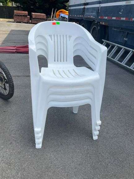 Four White Plastic Stackable Patio Chairs