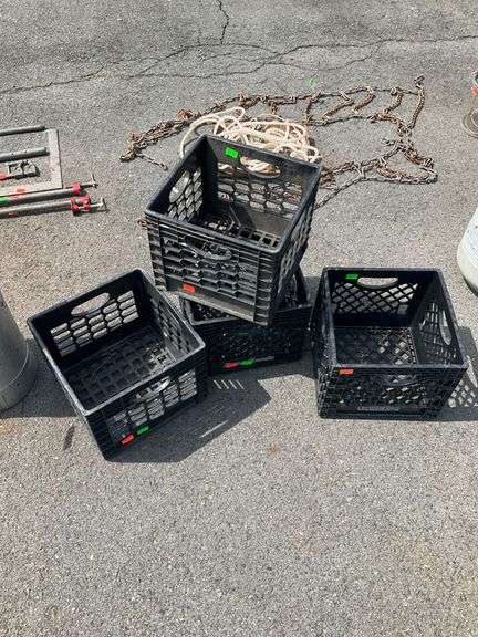 Four Black Plastic Crates With Cracked Features