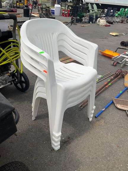 Four White Stackable Plastic Patio Chairs