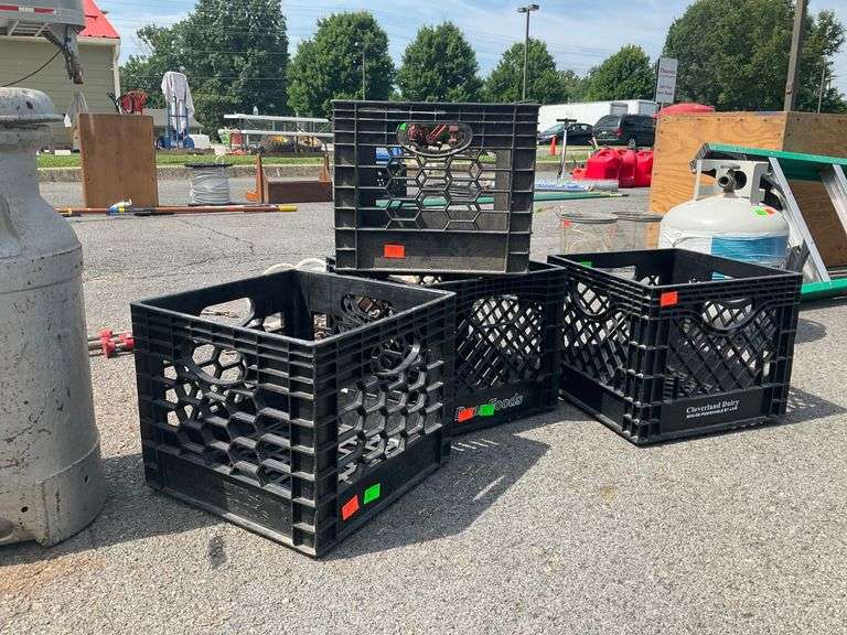 Four Black Plastic Crates With Cracked Features