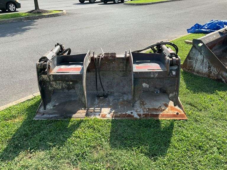 Loader Bucket with Grabbles, quick detach skid loader type, 5 1/2 foot wide bucket, Note the grable portion as it connects to the bucket top needs welded see photos as they will show. Works as were told just needs repairs. Loader available to load so bring something appropriate to load onto. Sells as is.