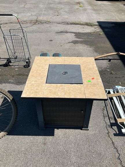 Propane Firepit with Lava Rocks and Woven Cabinet Design
