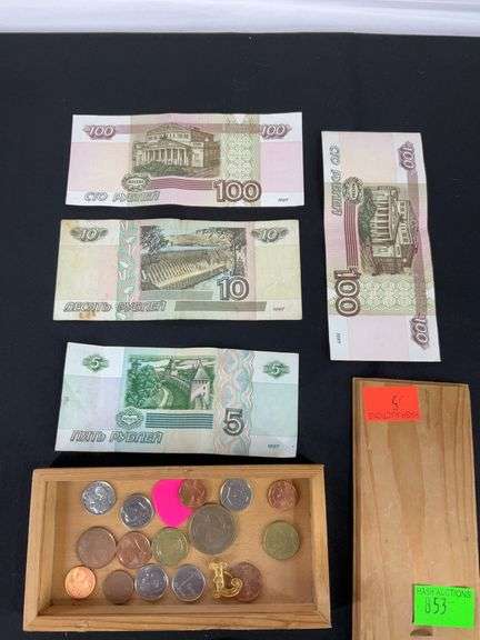 Wooden box with foreign coins and four foreign bills