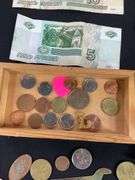 Wooden box with foreign coins and four foreign bills